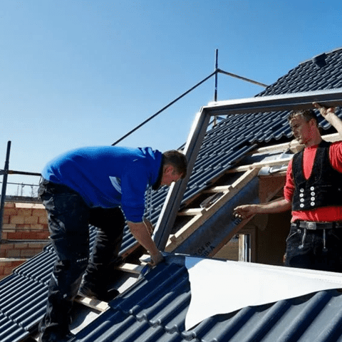 employees install a roof window