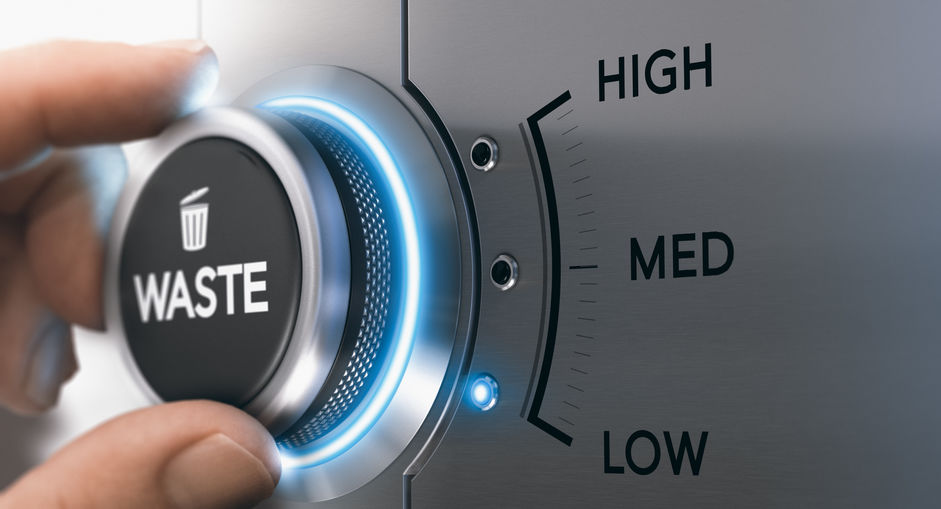 Hand turning knob to select the lowest waste level, grey and blue tones. Lean management and manufacturing optimization process concept. Composite image between a hand photography and a 3D background. Be one solutions