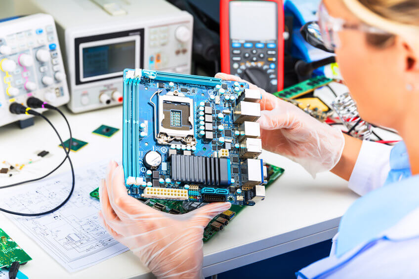 Anritsu_Integrated Circuit Young female digital electronic engineer examining computer PC motherboard in laboratory